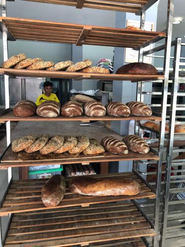 a shelf filled with lots of different types of bread at Phangan Guest House in Thong Sala