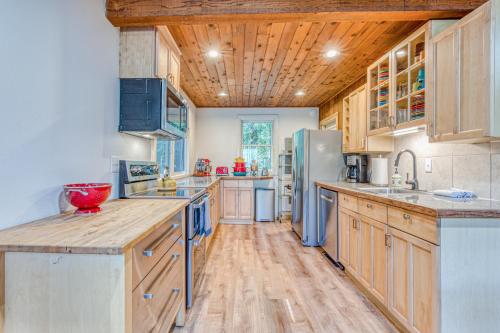 a large kitchen with wooden cabinets and wooden floors at Riverside Sanctuary in Rhododendron