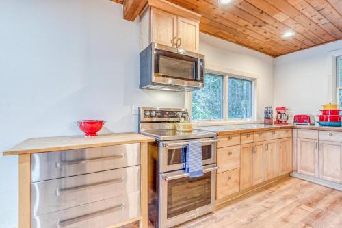 a kitchen with wooden cabinets and stainless steel appliances at Riverside Sanctuary in Rhododendron