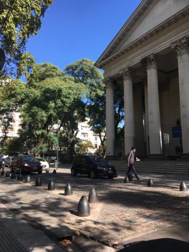 a man walking in front of a building at Dormy en Belgrano in Buenos Aires