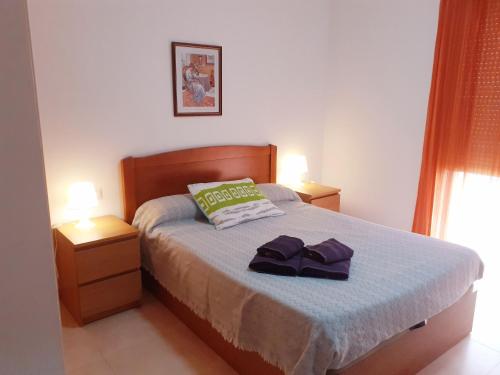 a bedroom with a bed with two towels on it at EDIFICIO ALGAIDA - NEW VISTA MONTAÑA - PLAYA DE LA CONCHA in Oropesa del Mar