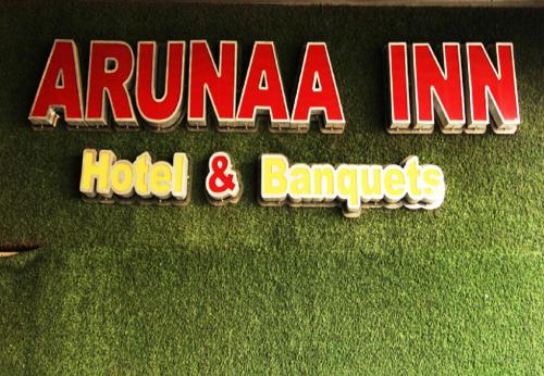 a sign for a hotel and ban at Arunaa Inn Airport Hotel,Chennai in Chennai