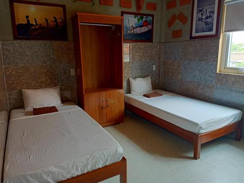 Ένα ή περισσότερα κρεβάτια σε δωμάτιο στο Terra Cotta Homestay