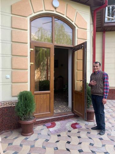 a man standing in the doorway of a house at Hotel Rahmon in Samarkand