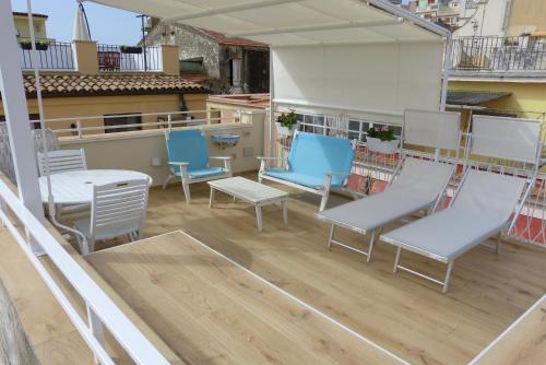 a balcony with chairs and tables on a building at The Sorabellas in Gaeta