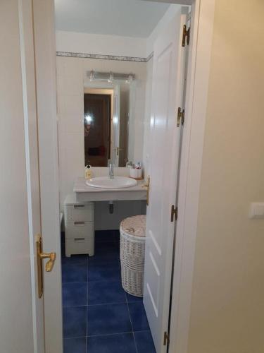 a bathroom with a sink and a mirror at Luceros in Rota