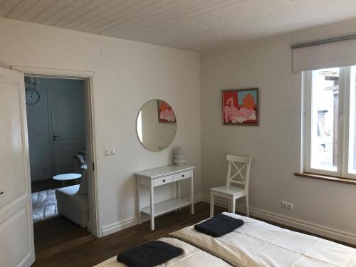 a bedroom with a bed and a mirror at Lossi Apartment in Kuressaare