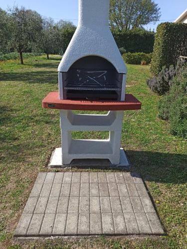 a pizza oven sitting on top of a field at Agriturismo il Giardino in Saturnia
