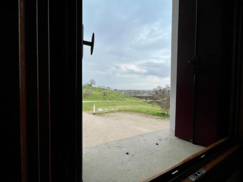 an open window with a view of a field at Agriturismo Vecio Portico in Marostica