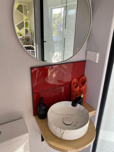 a bathroom with a toilet and a mirror at Ross Beach TOP10 Holiday Park in Ross