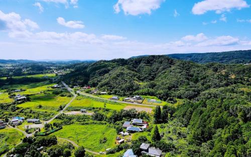an aerial view of a village in the mountains at 和心村ー古民家とグランピングと自然森山川海 in Minato