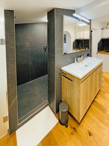 a bathroom with a sink and a shower at Boutique-Pension Jägerwirt in Scheffau am Wilden Kaiser
