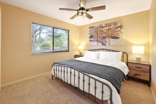 a bedroom with a bed and a ceiling fan at Blue Cocoon in Cambria