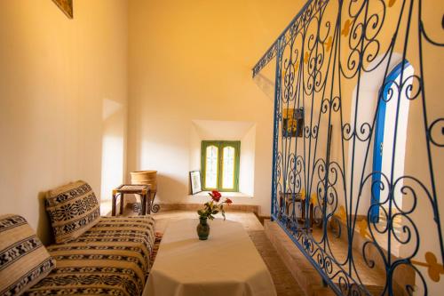 a living room with a couch and a iron gate at Palais Riad Hida in Oulad Berhil