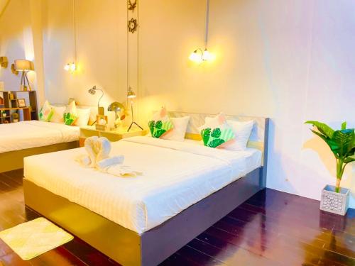 a bedroom with two beds with towels on them at Primego Boutique Hotel in Phuket Town