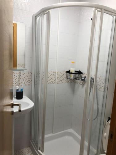 a bathroom with a shower and a tub and a sink at Precioso apartamento con vistas al mar en Carnota in Carnota