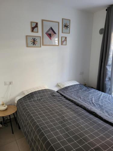 a bedroom with a bed and some pictures on the wall at Beautiful, modern apartment in sunny Corralejo in Corralejo