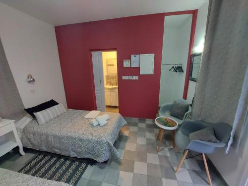 a small bedroom with a bed and a chair at Magdalene's City House Inn in Larnaka