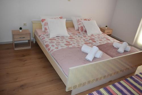 a bedroom with a large bed with two pillows at Kampor 211 in Kampor