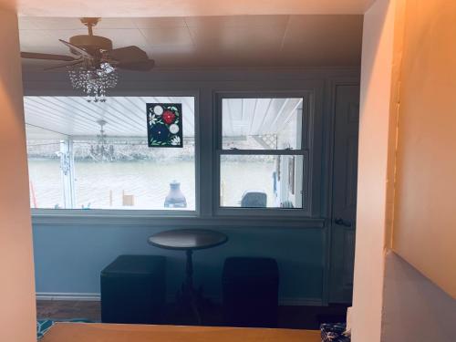 a room with a window and a stool and a table at Cedar Island Xanadu in Kingsville