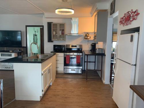 a kitchen with a sink and a stove top oven at Cedar Island Xanadu in Kingsville