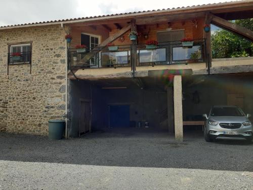 a car parked in the garage of a building at La grange des chouettes in Ilheu