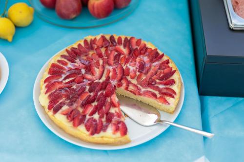 a pizza with strawberries on a plate on a table at Fuori Rotta in Avola