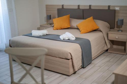 a bedroom with a bed with two towels on it at Fuori Rotta in Avola