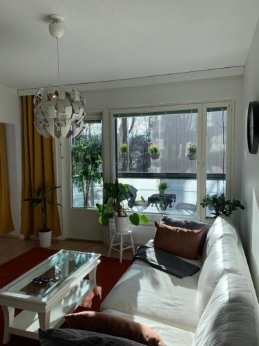 a living room with a white couch and a table at Holiday Home Turku City in Turku