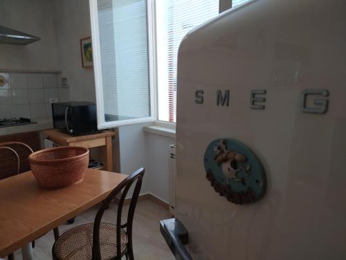 a kitchen with a refrigerator with a donut on it at Cà del borgo Historic Village in Toscolano Maderno