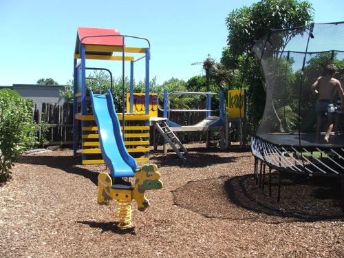 a playground with a blue and yellow slide at New Plymouth TOP 10 Holiday Park in New Plymouth