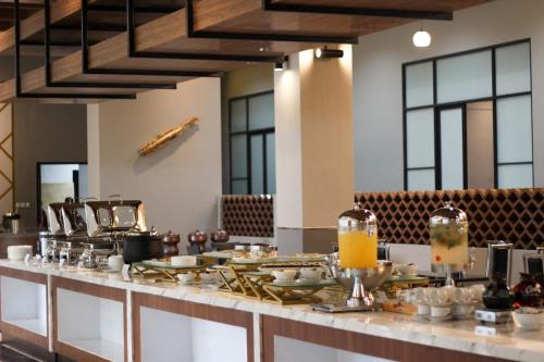 a buffet line with food on top of it at Grand Miami Hotel in Malang