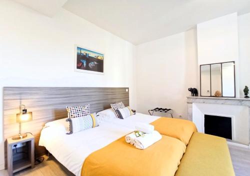 1 dormitorio con 1 cama grande y chimenea en Viva Riviera - 3 Rue Commandant André, en Cannes