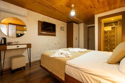a bedroom with a bed with white towels on it at Candy Hotel in Istanbul