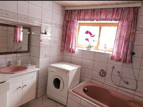 a bathroom with a washing machine and a sink at Haus Edda Einfamilienhaus in Gundersheim