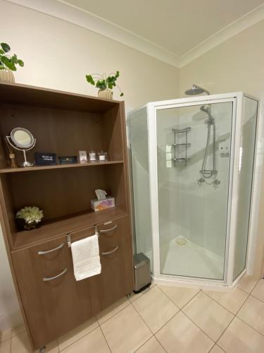 a bathroom with a shower with a glass shower stall at Hideaway on Hume in Boonah