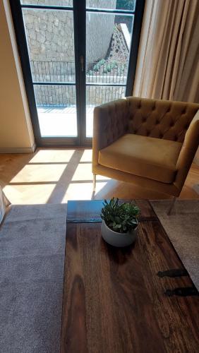 a living room with a couch and a plant on a table at DESIGN hotel VERBENICUM in Vrbnik