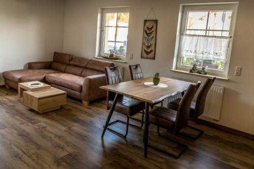 a living room with a table and a couch at Lübbenauer Spreewaldnest in Lübbenau