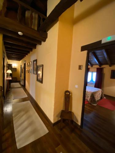 a hallway with a room with a bed and a window at Casa Rural Dos Reales in San Cristóbal de Boedo