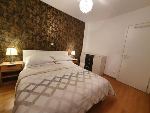 a bedroom with a bed and a wall mural at Beata East Side apartment in Split