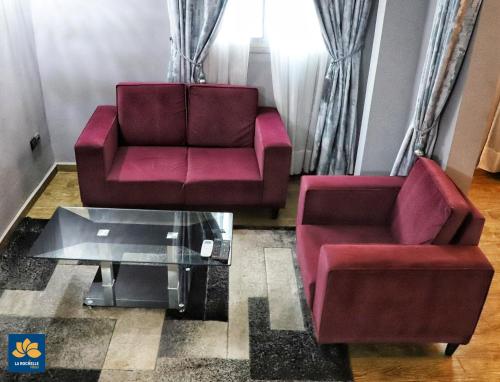 a living room with two chairs and a coffee table at LA ROCHELLE HOTEL in Yaoundé