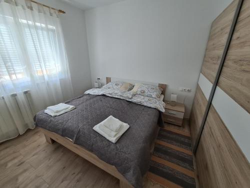 a bedroom with a large bed and a window at Šimun in Karlovac