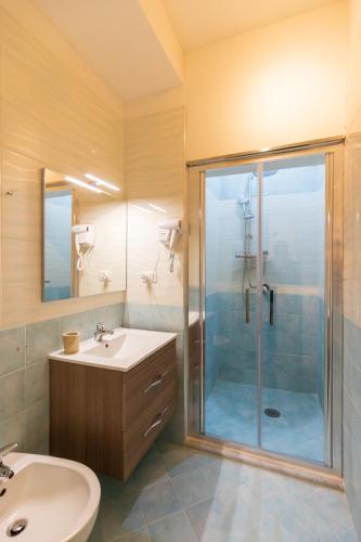 a bathroom with a shower and a sink at Suites Trinità in Toledo street in Naples