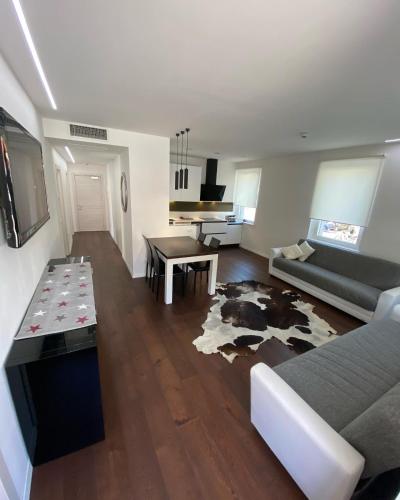 a living room with a couch and a table at Hotel Aurora & Appartamenti in Nago-Torbole