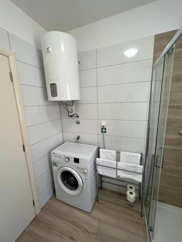 a washer and dryer in a small bathroom at Apartment Sunrise with private parking in Pula