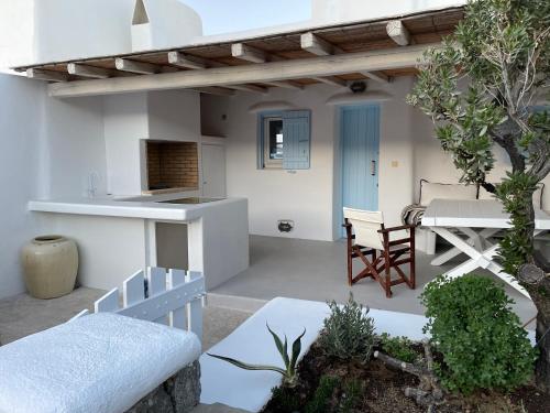 a patio with a kitchen and a table and chairs at Villa ANASA private Pool & Jacuzzi 8pax at Panormos in Panormos Mykonos