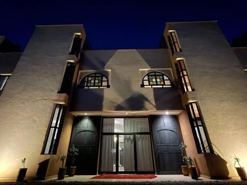 a house with black doors and windows at night at kasbah yu palace in Ouarzazate