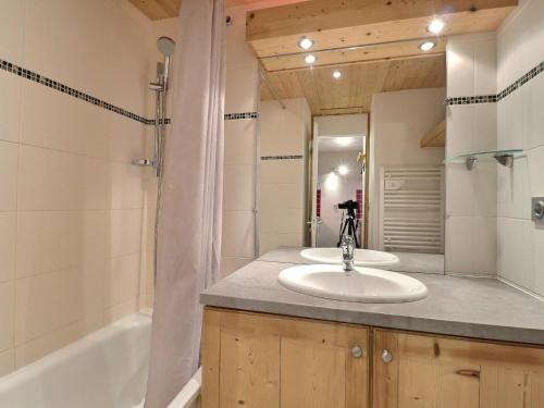 a bathroom with a sink and a bath tub at Studio Méribel, 1 pièce, 4 personnes - FR-1-182-194 in Les Allues