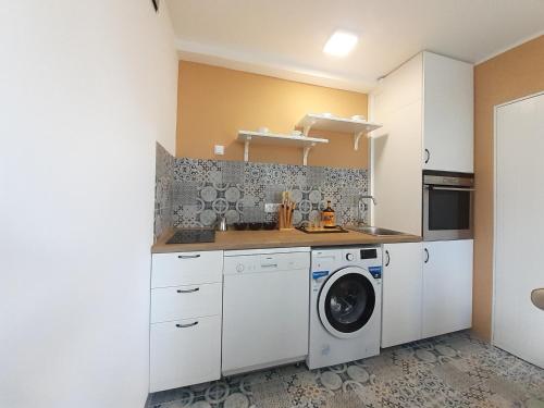 a kitchen with a washer and a washing machine at Apartman Jovana in Sremska Mitrovica
