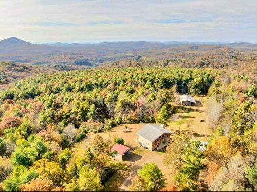 an aerial view of a house in the middle of a forest at Lodges at Buffalo Mountain- 168 private acres in Floyd